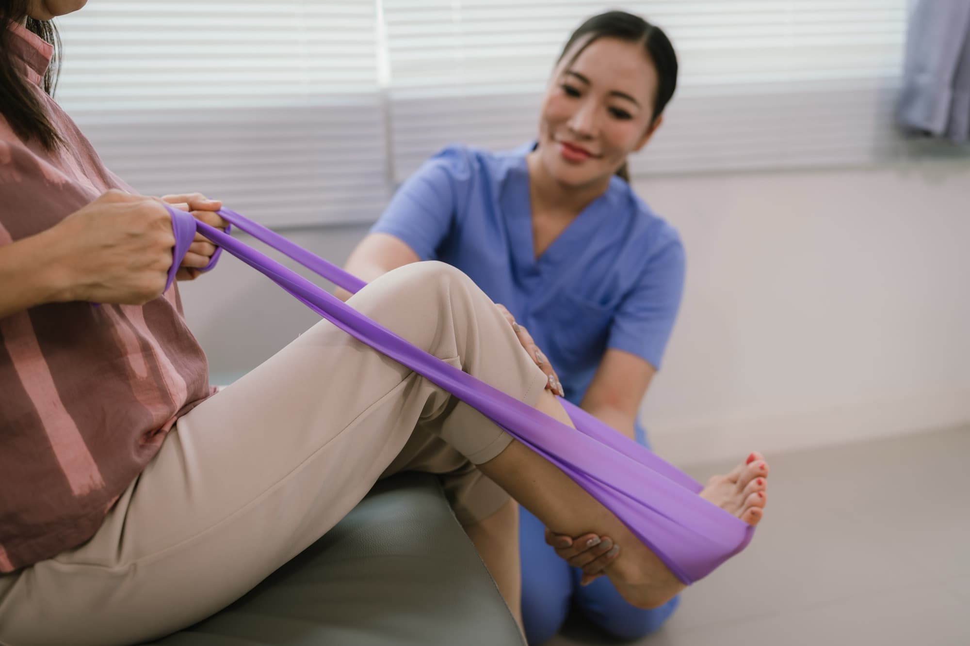 Guided resistance-band rehabilitation exercises with a physical therapist